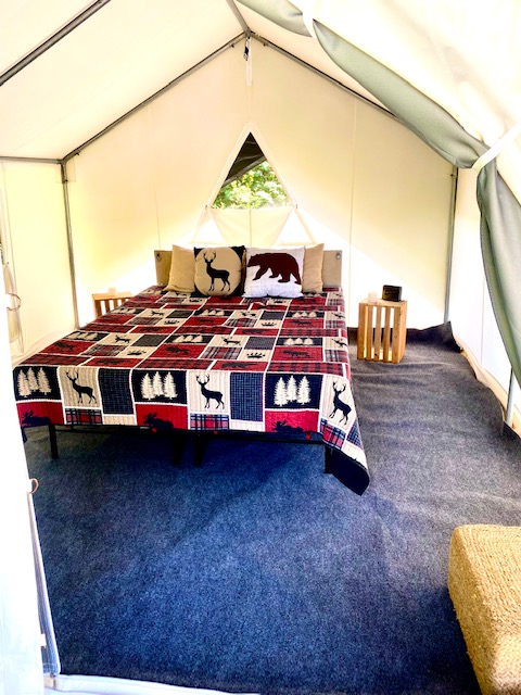Interior of Sublime Wild Vine safari tent — premium linens and curated decor